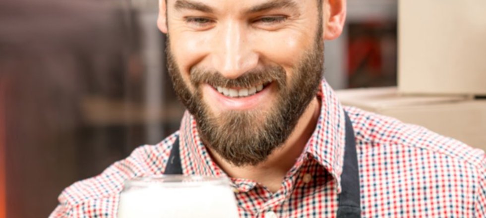 Man with glass of beer and bottle