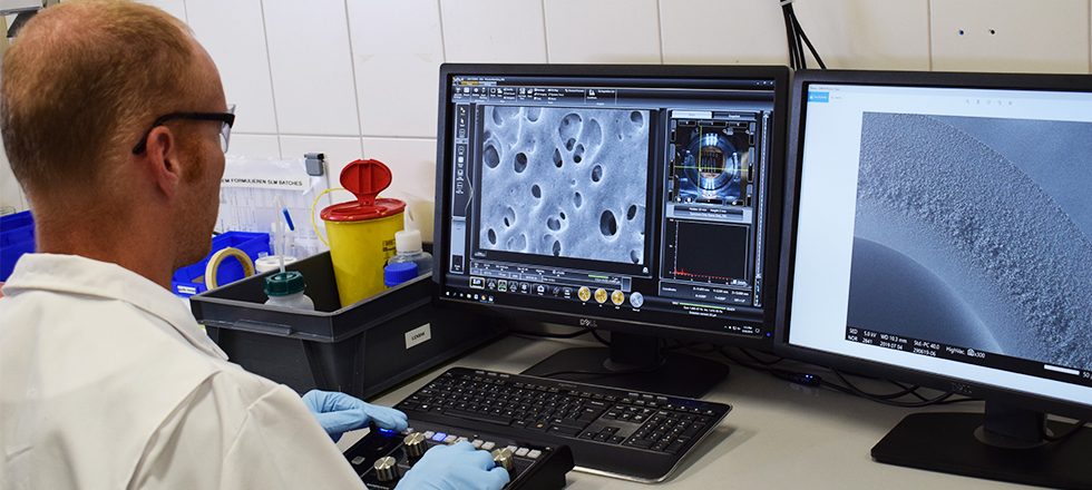 Laboratory technician looking at screen